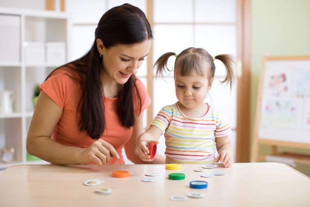 Kid plays logical game at psychologist office